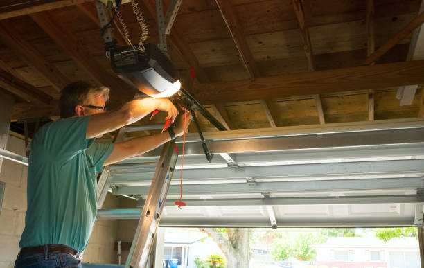 Man on a ladder installing a garage door